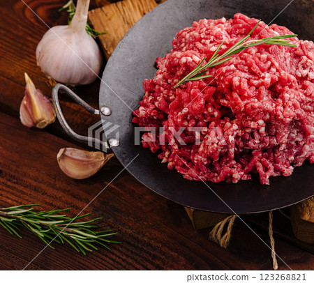 Fresh ground beef with garlic and herbs on wooden table 123268821