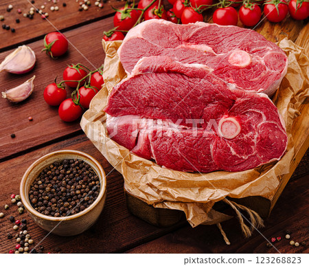 Fresh cuts of meat neatly arranged with cherry tomatoes and spices 123268823