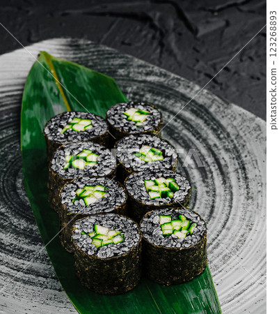 Sushi rolls garnished with cucumber on a decorative plate Sushi rolls garnished with cucumber on a decorative plate 123268893