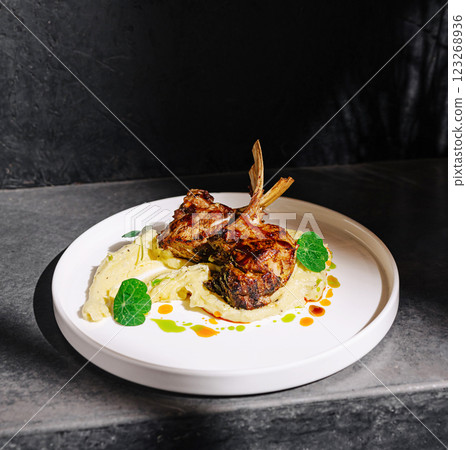 Grilled lamb chops served on creamy puree with garnish Grilled lamb chops served on creamy puree with garnish 123268936