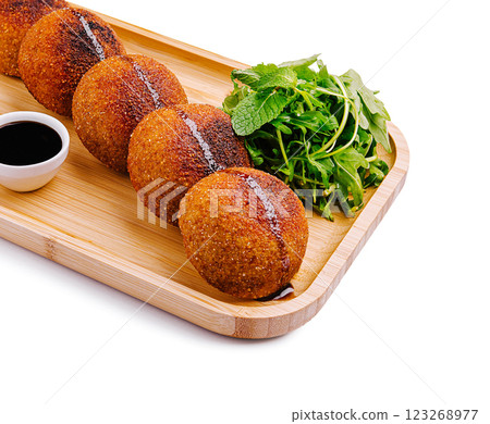 Crispy golden dumplings served with fresh herbs and sauce Crispy golden dumplings served with fresh herbs and sauce 123268977