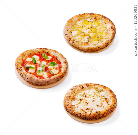 Three unique pizzas featuring fresh ingredients on wooden boards 123269035