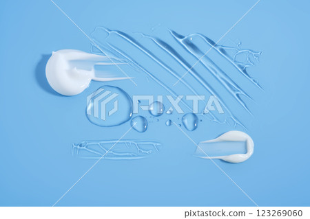 Drops and smears of cosmetic products on a blue background. Drops and smears of cosmetic products on a blue background. 123269060