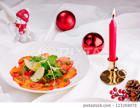 Holiday salad with decorative candle and seasonal ornaments Holiday salad with decorative candle and seasonal ornaments 123269078