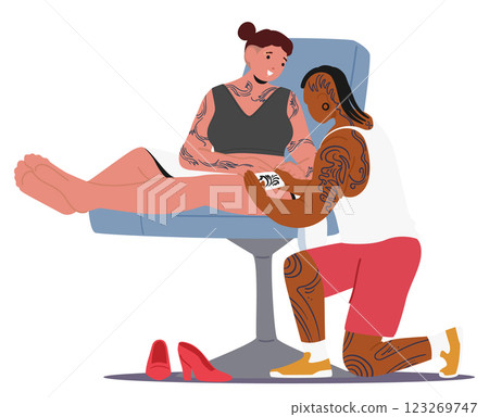 Hipster woman tattoo artist making painting on client leg skin with unstable, washable print 123269747