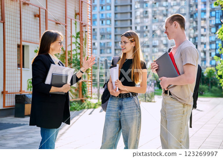 Group of college students talking with female teacher Group of college students talking with female teacher 123269997