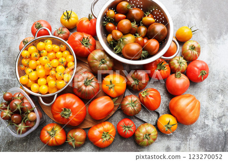 Background of fresh heirloom red tomatoes on cutting board, view from above, organic fruit. Space for text. Top view Background of fresh heirloom red tomatoes on cutting board, view from above, organic fruit. Space for text. Top view 123270052