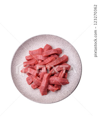 Juicy raw beef cut into slices with salt and spices Juicy raw beef cut into slices with salt and spices 123270362