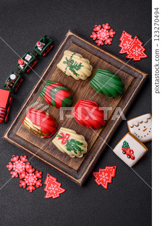 Sweet madeleine sponge cookies covered with colored chocolate Sweet madeleine sponge cookies covered with colored chocolate 123270494