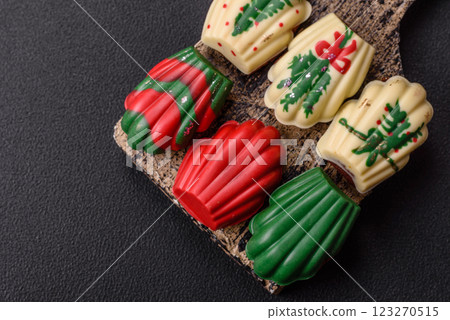 Sweet madeleine sponge cookies covered with colored chocolate 123270515