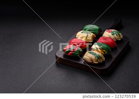 Sweet madeleine sponge cookies covered with colored chocolate 123270539