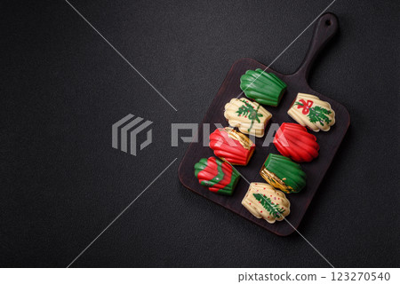 Sweet madeleine sponge cookies covered with colored chocolate Sweet madeleine sponge cookies covered with colored chocolate 123270540