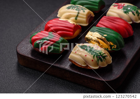 Sweet madeleine sponge cookies covered with colored chocolate Sweet madeleine sponge cookies covered with colored chocolate 123270542
