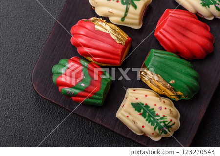 Sweet madeleine sponge cookies covered with colored chocolate Sweet madeleine sponge cookies covered with colored chocolate 123270543
