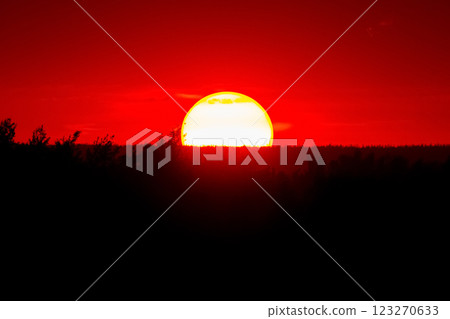 Spectacular sunset with big round sun and red sky. Spectacular sunset with big round sun and red sky. 123270633