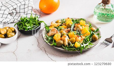 Vegetarian salad with cauliflower, orange, arugula and olives on a plate web banner 123270680