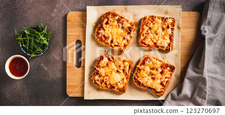 Homemade bread pizza with bacon and cheese on a board on the table top view web banner 123270697
