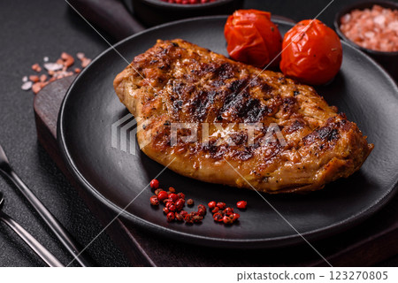 Juicy pork steak baked on the grill with salt, spices and herbs 123270805