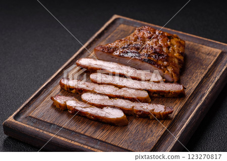 Juicy pork steak baked on the grill with salt, spices and herbs 123270817