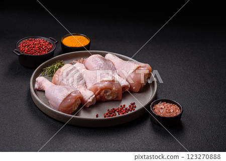Raw chicken legs with salt, spices and herbs Raw chicken legs with salt, spices and herbs 123270888