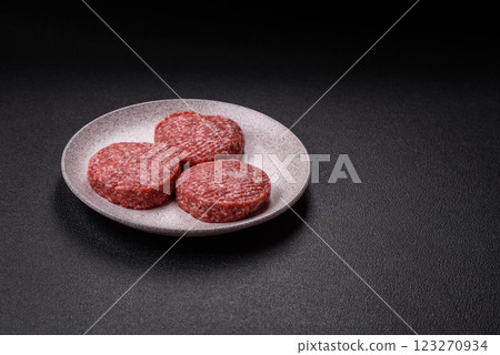 Fresh raw ground beef burger patty with salt and spices 123270934