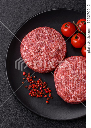Fresh raw ground beef burger patty with salt and spices 123270942