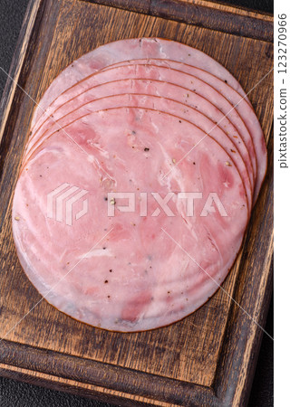 Smoked ham with salt, spices and herbs cut into round slices Smoked ham with salt, spices and herbs cut into round slices 123270966