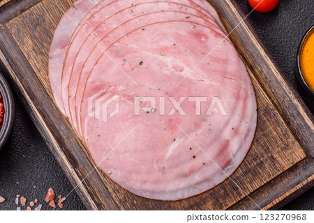 Smoked ham with salt, spices and herbs cut into round slices Smoked ham with salt, spices and herbs cut into round slices 123270968