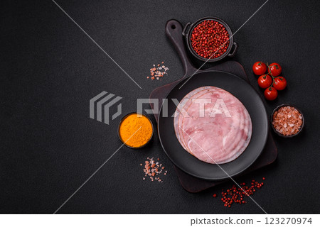 Smoked ham with salt, spices and herbs cut into round slices 123270974