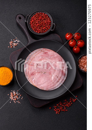 Smoked ham with salt, spices and herbs cut into round slices 123270975