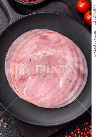 Smoked ham with salt, spices and herbs cut into round slices 123270977