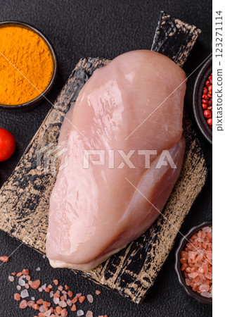Pieces of raw chicken or turkey fillet with salt, spices and herbs Pieces of raw chicken or turkey fillet with salt, spices and herbs 123271114
