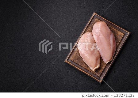 Pieces of raw chicken or turkey fillet with salt, spices and herbs 123271122