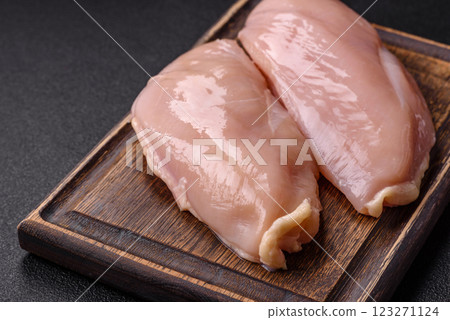 Pieces of raw chicken or turkey fillet with salt, spices and herbs 123271124