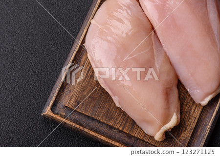 Pieces of raw chicken or turkey fillet with salt, spices and herbs 123271125