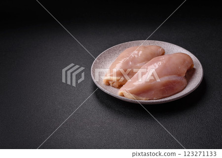 Pieces of raw chicken or turkey fillet with salt, spices and herbs Pieces of raw chicken or turkey fillet with salt, spices and herbs 123271133