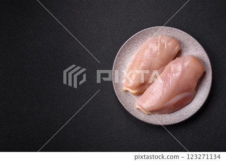Pieces of raw chicken or turkey fillet with salt, spices and herbs Pieces of raw chicken or turkey fillet with salt, spices and herbs 123271134