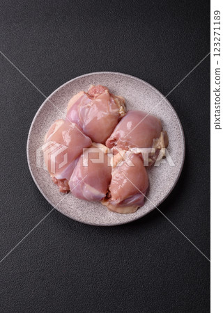 Fresh raw chicken thigh fillets with salt, spices and herbs Fresh raw chicken thigh fillets with salt, spices and herbs 123271189