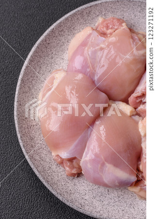 Fresh raw chicken thigh fillets with salt, spices and herbs Fresh raw chicken thigh fillets with salt, spices and herbs 123271192