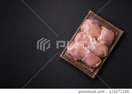 Fresh raw chicken thigh fillets with salt, spices and herbs 123271199