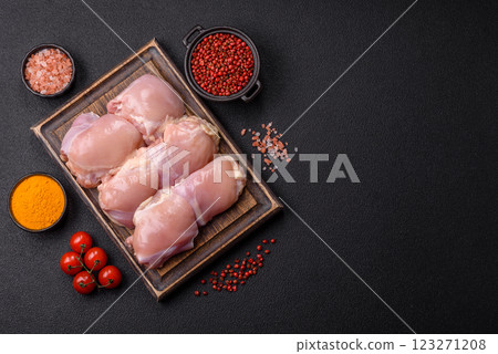 Fresh raw chicken thigh fillets with salt, spices and herbs Fresh raw chicken thigh fillets with salt, spices and herbs 123271208