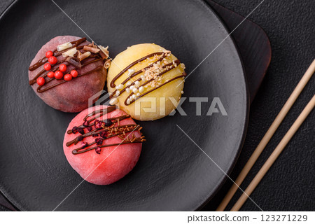 Delicious colorful asian mochi sweets with rice dough shell and fruit filling Delicious colorful asian mochi sweets with rice dough shell and fruit filling 123271229
