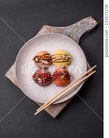 Delicious colorful asian mochi sweets with rice dough shell and fruit filling Delicious colorful asian mochi sweets with rice dough shell and fruit filling 123271256