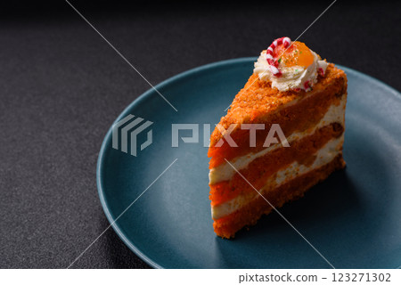 Piece of sweet layer cake with pumpkin or citrus flavor with cream 123271302
