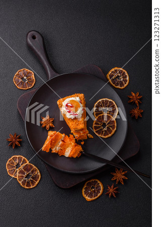 Piece of sweet layer cake with pumpkin or citrus flavor with cream 123271313