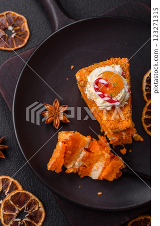 Piece of sweet layer cake with pumpkin or citrus flavor with cream 123271315