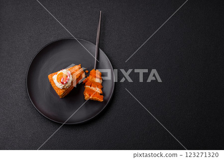 Piece of sweet layer cake with pumpkin or citrus flavor with cream 123271320