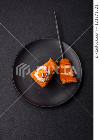 Piece of sweet layer cake with pumpkin or citrus flavor with cream 123271321