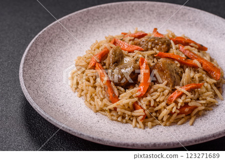 Delicious fresh pilaf with rice, carrots, meat, onions, spices and berries Delicious fresh pilaf with rice, carrots, meat, onions, spices and berries 123271689