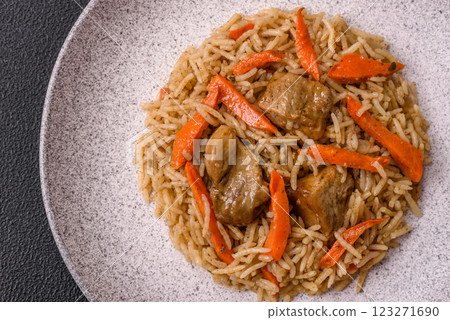 Delicious fresh pilaf with rice, carrots, meat, onions, spices and berries 123271690
